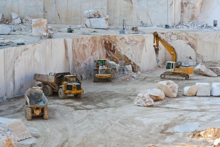 Heavy machinery moving material on an excavation site