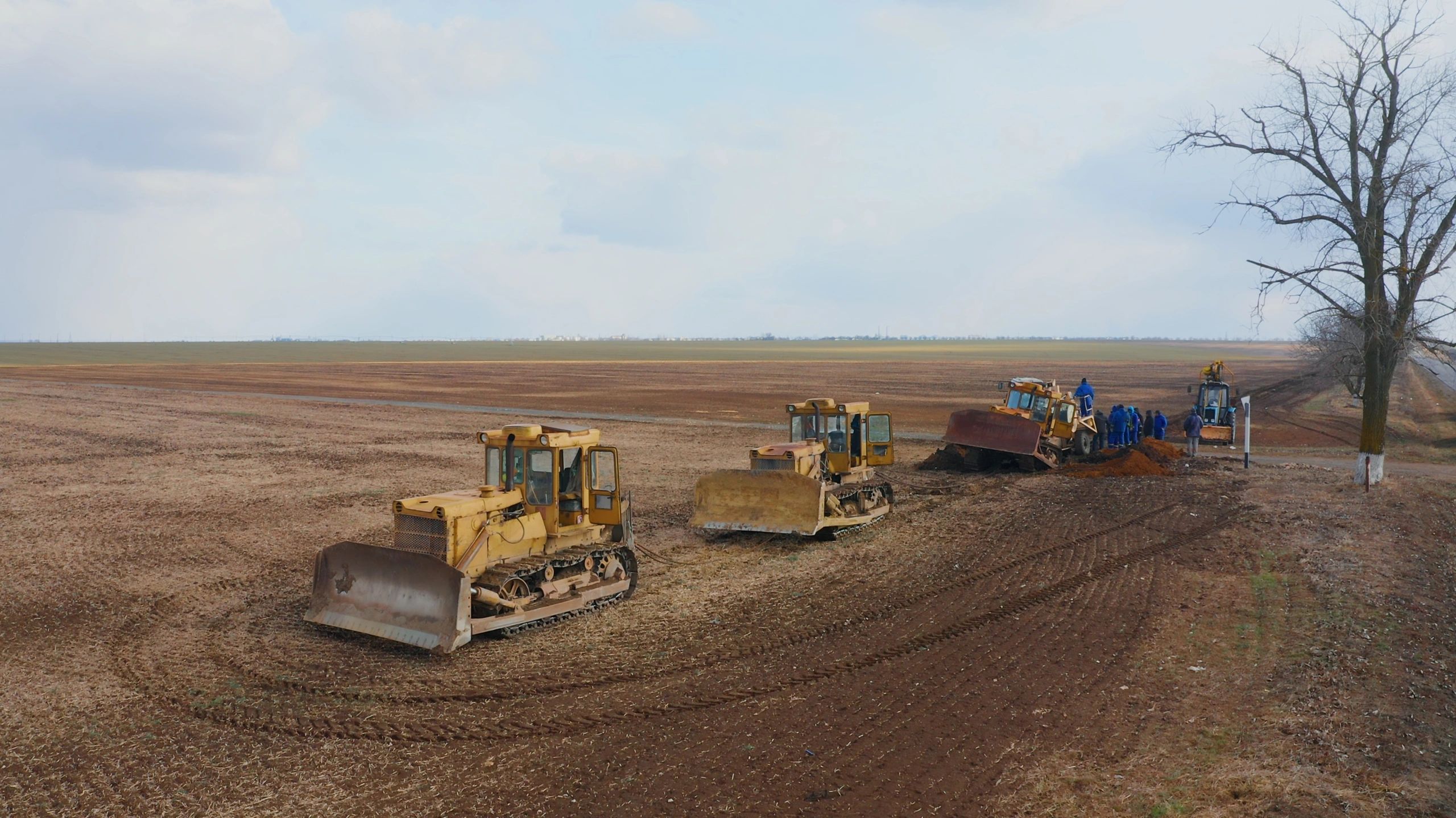 Heavy equipment working on a large dirt field