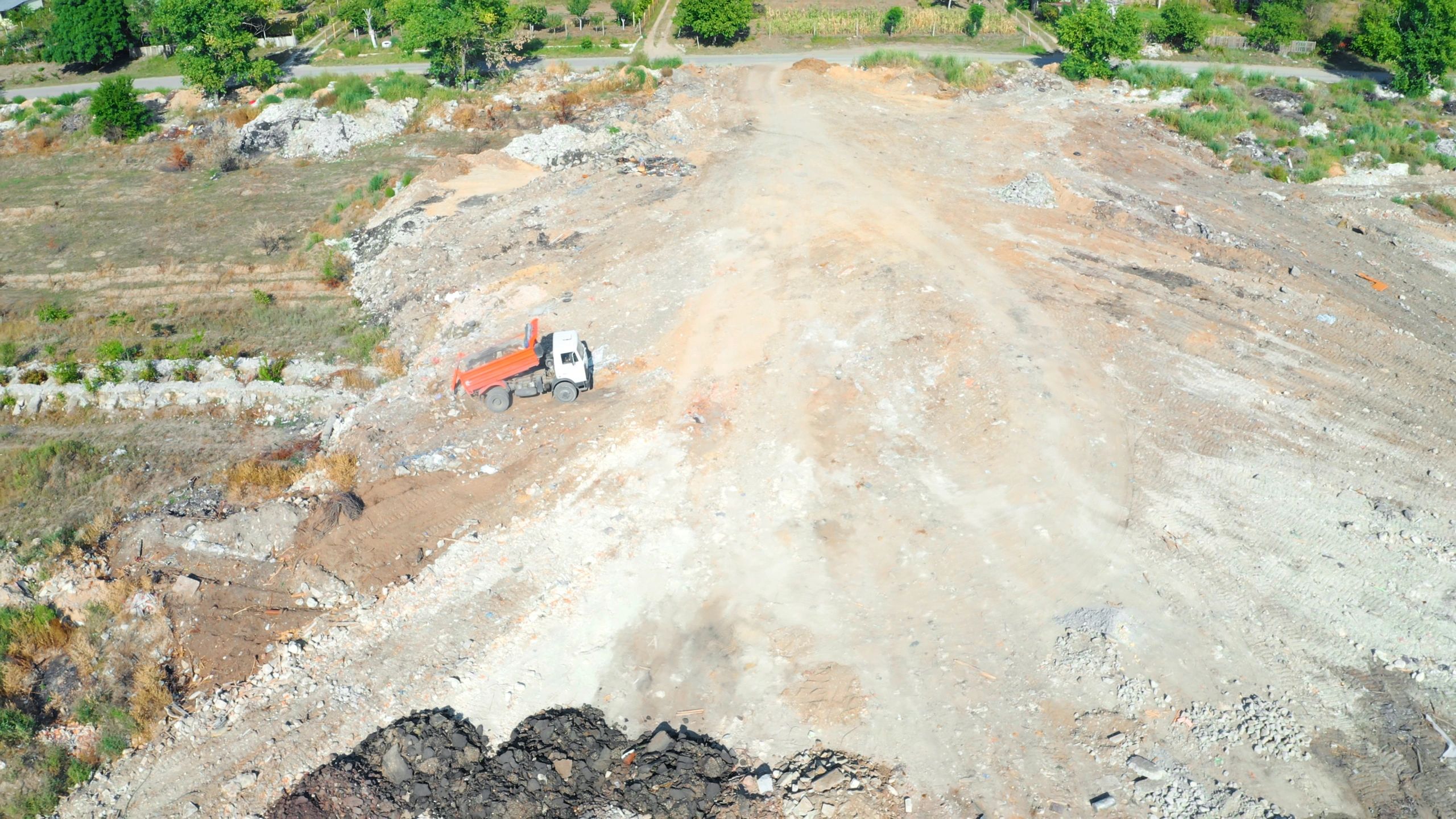 Dump truck working on a land clearing and earthmoving site