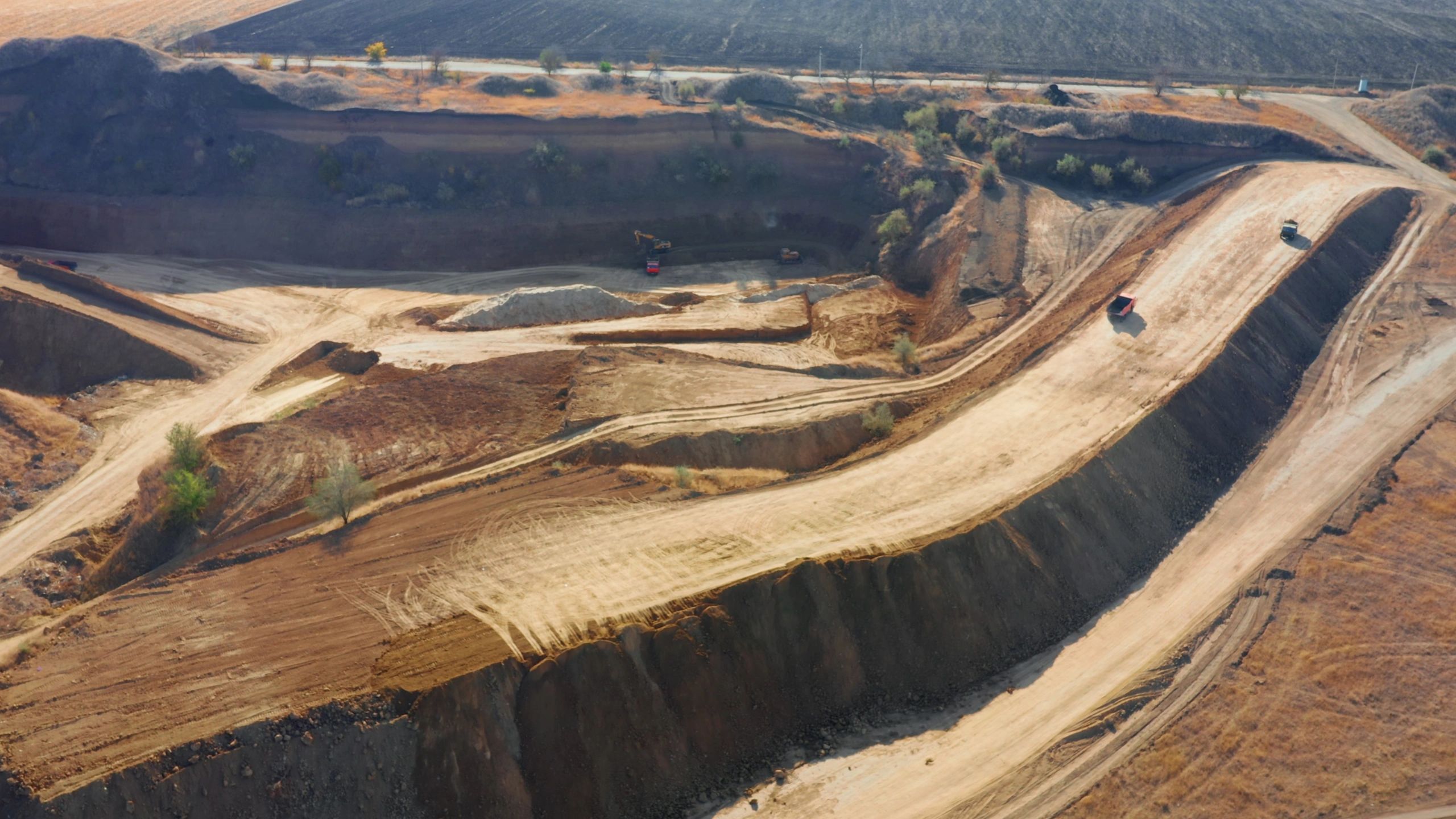Aerial view of heavy machinery and trucks on a worksite