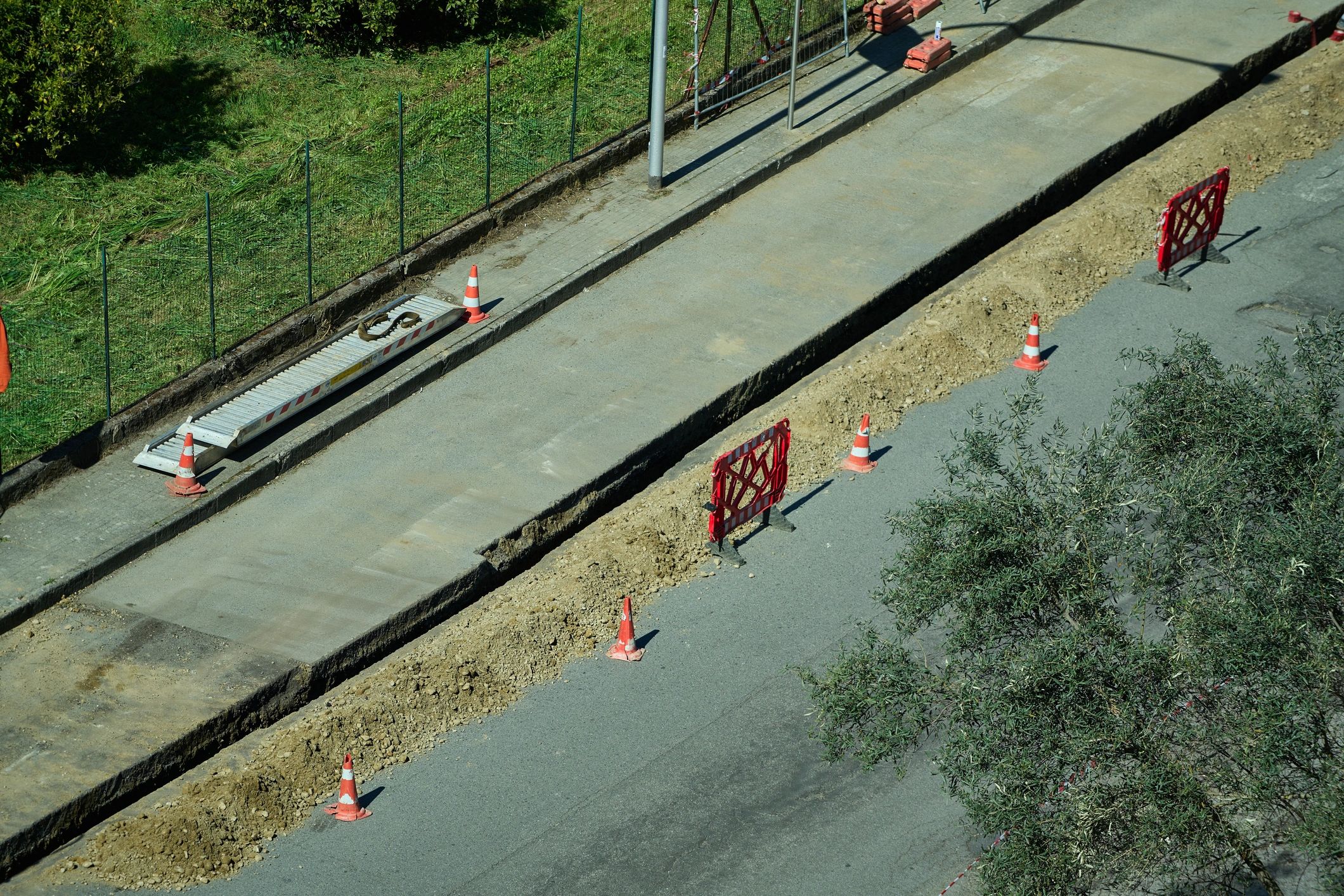 Open construction trench with barriers and site access