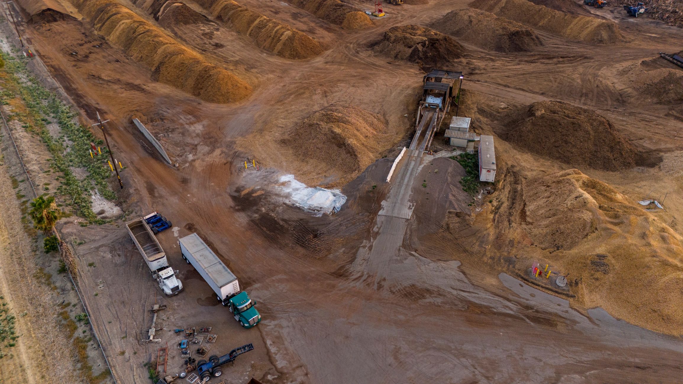 Industrial site with trucks and material handling operations